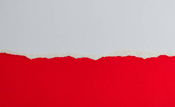 istock Tear white paper to reveal the red background 2212326022
