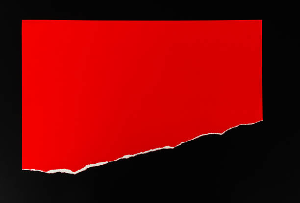 istock Half a piece of red paper on black background 2212326063
