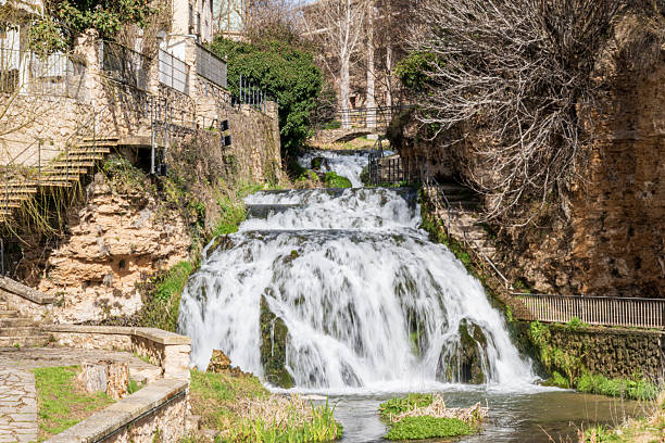 Waterfall that splits the town of Trillo De Guadalajara (Castilla La Mancha-Spain) in two. You can see the houses on one side of the waterfall, with beautiful views. There is a staircase to be able to contemplate the views.