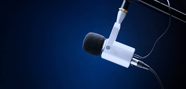 Microphone in studio. Professional studio microphone with a pop filter is suspended boom arm and studio lights. Set up mic for podcast voice over or recording high quality sound audio in a controlled.
