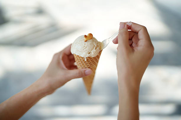 Close up shot of a cup of creamy ice cream on a hot summer day.