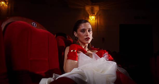 A captivating portrait drenched in deep red light, emphasizing shadows and artistic intensity.