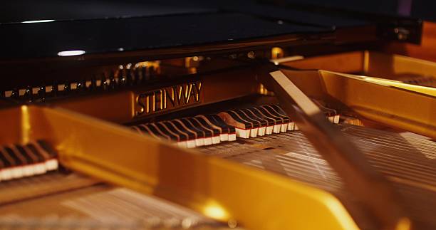 The inside of the piano while playing. Close-up