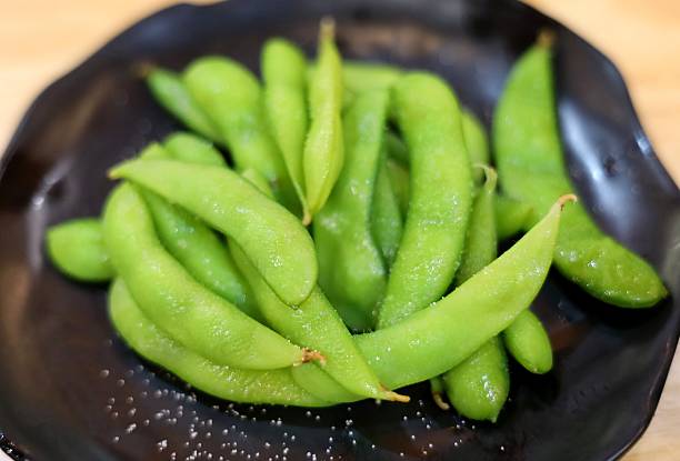 istock Edamame and salt on plate. 2212329056