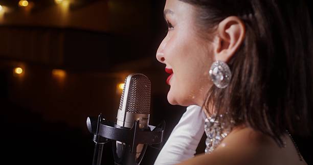 A singer on the stage. Solo performance by lamplight