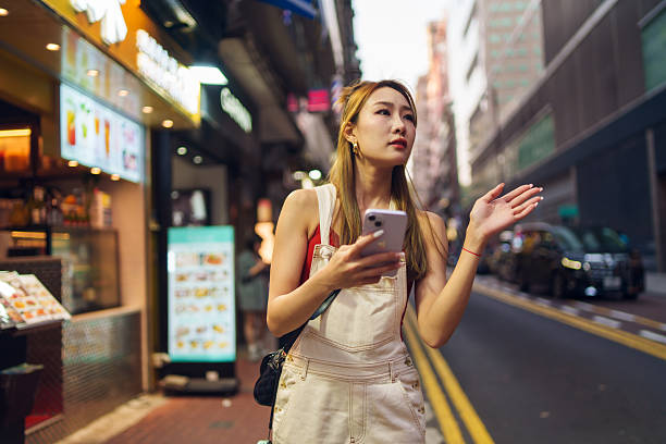 istock Woman lost in city, found by technology. 2212330010
