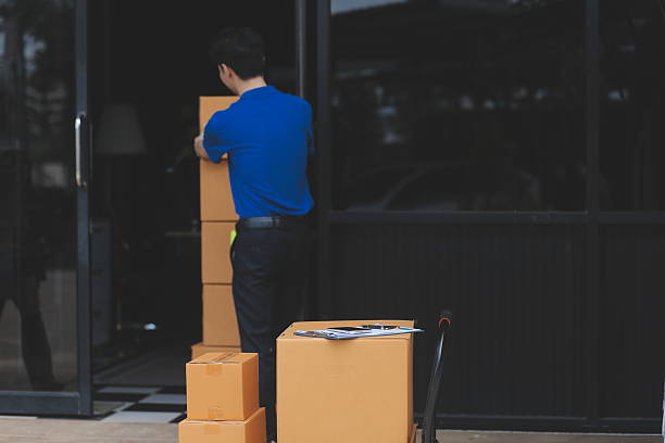 istock Truck Mover Unloading Van Carrying Boxes And Moving House 2212330721
