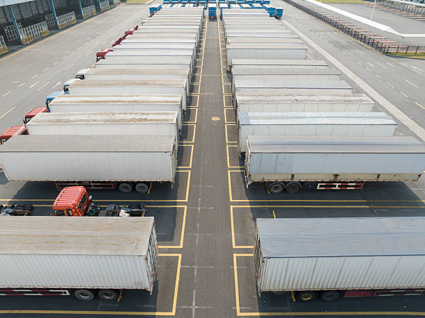 istock A row of logistics freight trucks, merchandise containers 2212330779