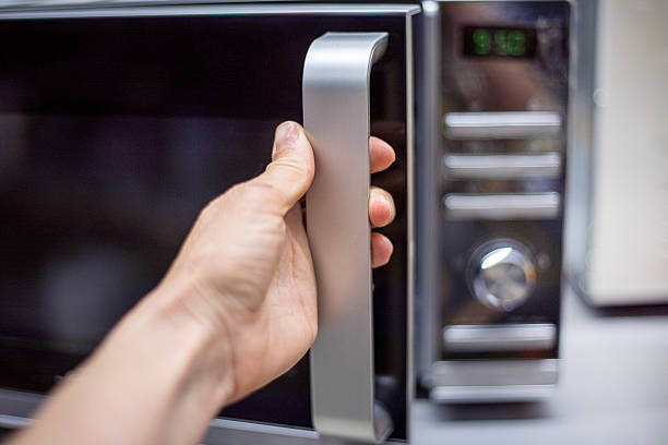 istock open the microwave for cooking and heating food 2212331579