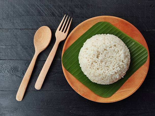 istock White rice on wooden plate on black wooden table background 2212332580