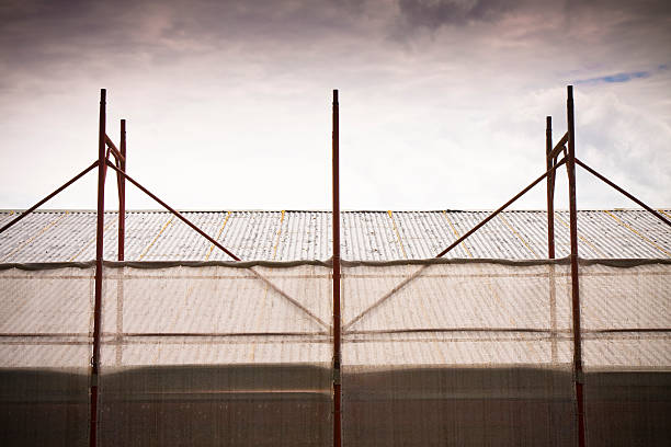 istock Metal scaffolding on a construction site built with prefabricated components to work safely on the facade of a building for the renovation of the plaster wall or realization of thermal insulation 2212333677
