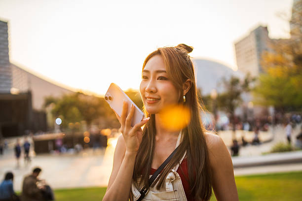 istock Woman sending a voice massage using smart phone. 2212335412