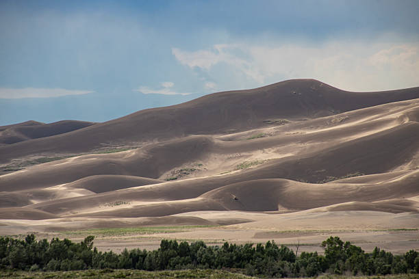istock Sand dunes form intricate patterns beneath an expansive sky in a tranquil desert landscape in Great Sand Dunes National Park 2212335947