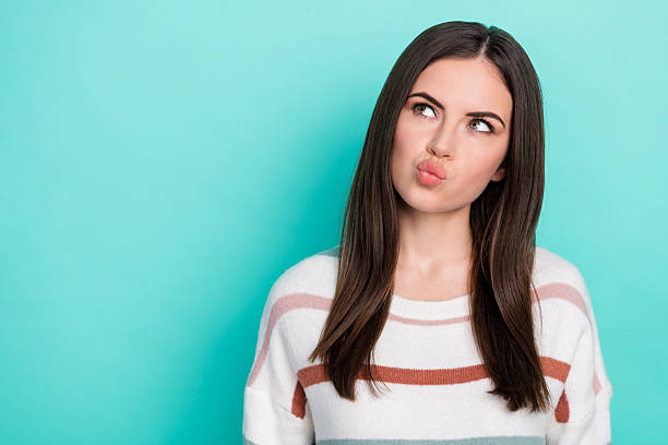 istock Photo of minded uncertain clever lady look empty space think wear striped pullover isolated blue color background 2212338499