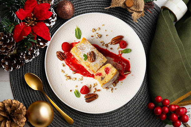 istock White chocolate brownie with walnuts and raspberries top view table with christmas decorations. 2212340726