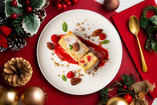 istock White chocolate brownie with walnuts and raspberries top view table with christmas decorations. 2212340776
