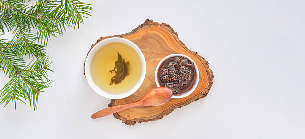 istock Herbal Tea and Pine Cone Jam on Wooden Board 2212341443