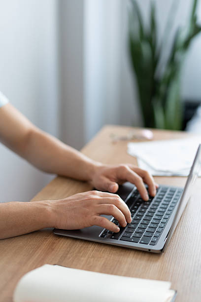 istock Freelancer working from home office typing on laptop keyboard 2212341623