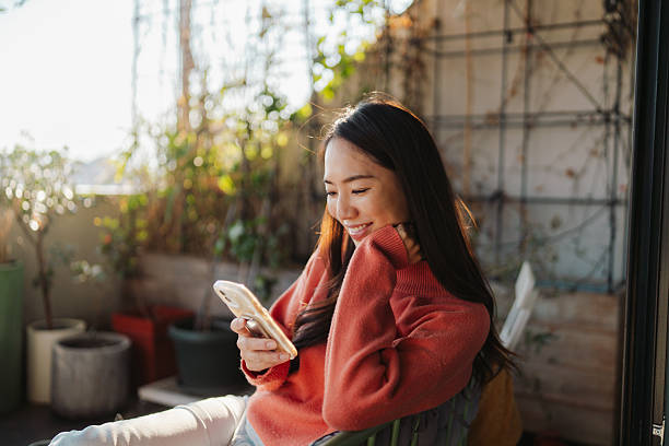 istock Young woman using mobile phone 2212342035
