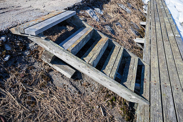 istock weathered old wooden stairs on a jetty 2212343228
