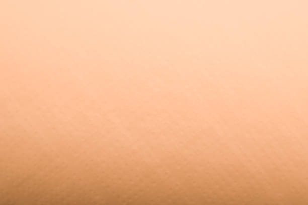 istock Light gradient paper backdrop, trendy peach fuzz color. Textures formed by cardboard or paper ancient of color soft orange. 2212343798