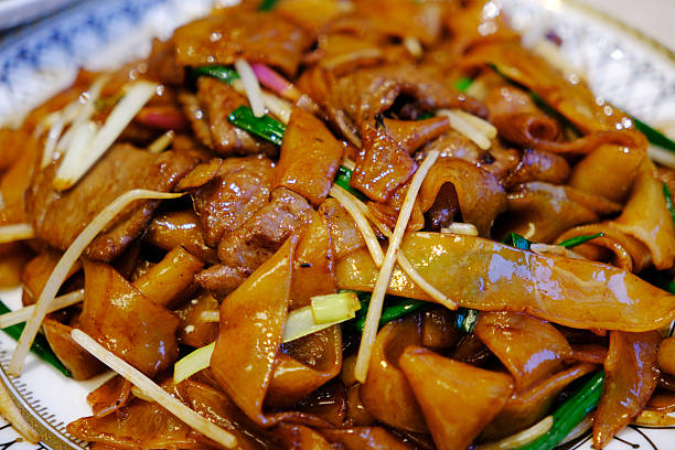 istock stir fried beef Shahe noodles, beef chow fun 2212344171
