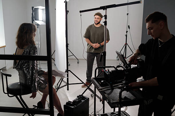 istock Backstage of Video Shoot with Production Crew Setting Up Equipment 2212344241