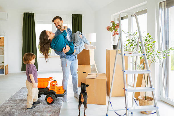 istock Cheerful Parents and Child And Pet with Relocation Boxes 2212344894