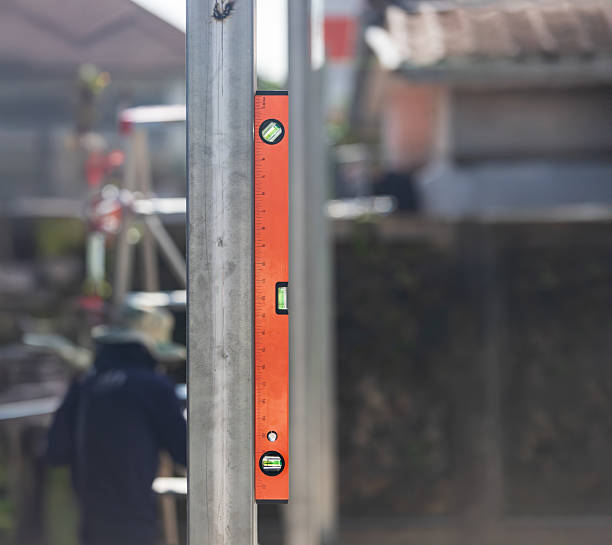 istock Construction worker use spirit level and measures the vertical of the iron pole in site. 2212344935