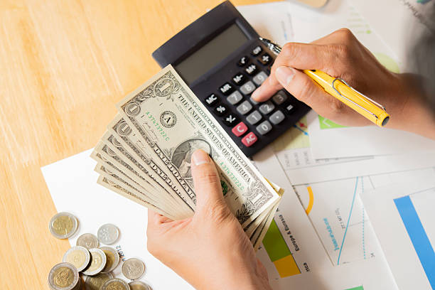istock Close-up view of man hand counting money. Selective focus on hand with banknotes. 2212345547