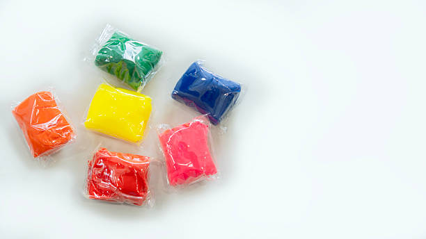istock Colorful clay for kids packed in clear plastic wrap on white background with copy space. 2212345850