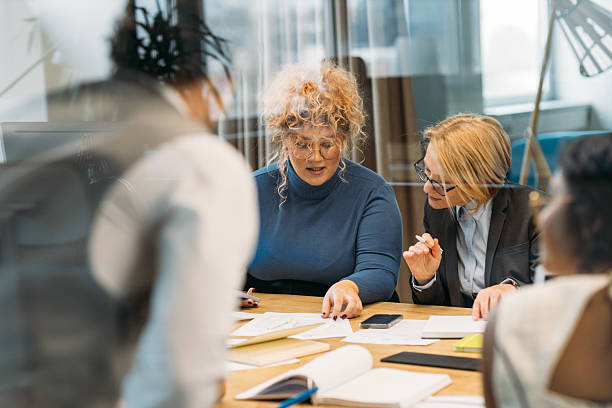 istock Two experienced female business managers reviewing forecast on paper. 2212346382