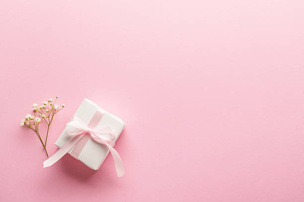 istock Pink flat lay background. Gift box with white flowers. 2212346471