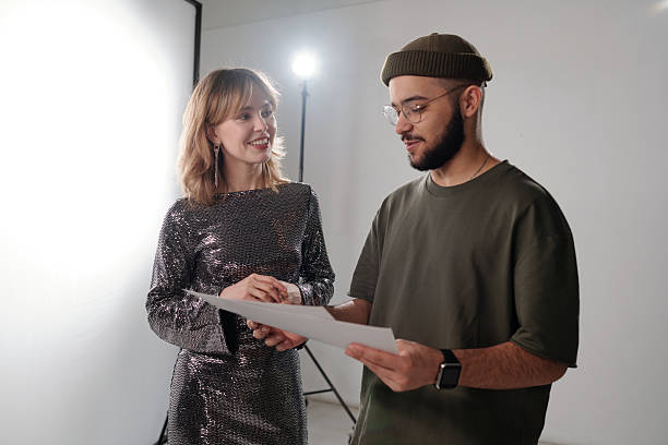 istock Young Director Talking to Smiling Woman Backstage and Holding Notes 2212346641