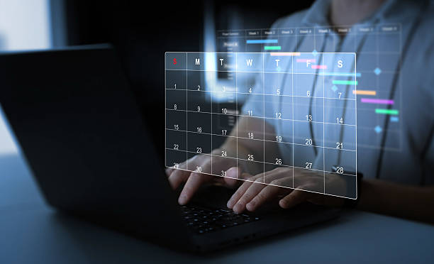 istock Man manages time to work efficiently and on time on all projects.Calendar work schedule, business plan concept.Managing a scheduled meeting. 2212346945
