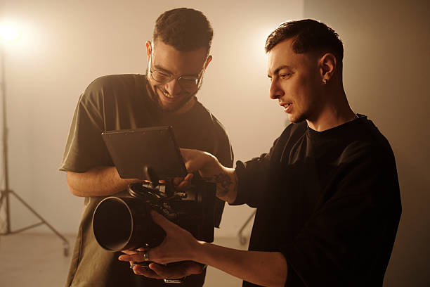 istock Videographers Reviewing Footage on Camera 2212347119