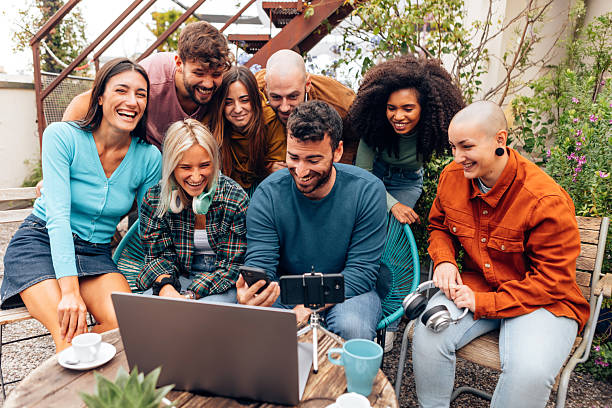 istock Content creators team laughing and working together on a video project using laptop and smartphone 2212348480