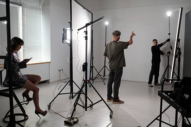 istock Production Crew Assistant Adjusting Lighting Equipment 2212349101