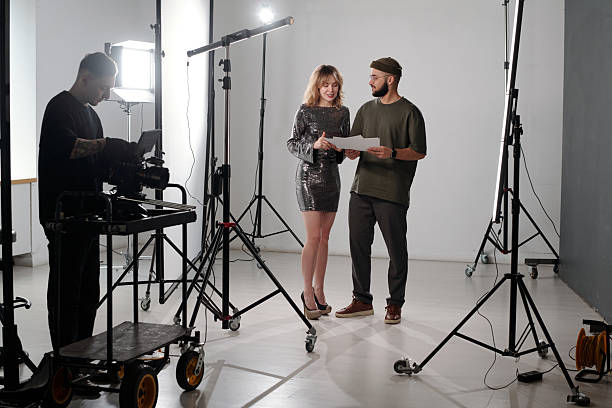 istock Filming Crew with Young Woman Preparing For Video Shoot 2212349312