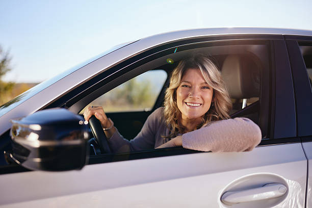 istock Happy woman enjoying while driving a car. 2212350083