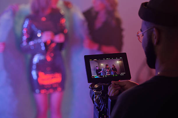 istock Director Monitoring Scene on Camera Display during Video Shoot 2212350103