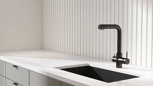 istock White marble kitchen counter with black undermount sink, faucet with wainscot stripe splash back in sunlight for interior design decoration, cooking, food, kitchenware product background 3D 2212350243