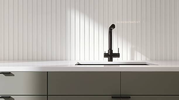 istock White marble kitchen counter with black undermount sink, faucet with wainscot stripe splash back in sunlight for interior design decoration, cooking, food, kitchenware product background 3D 2212350289