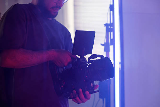 istock Production Crew Holding Professional Video Camera 2212350492