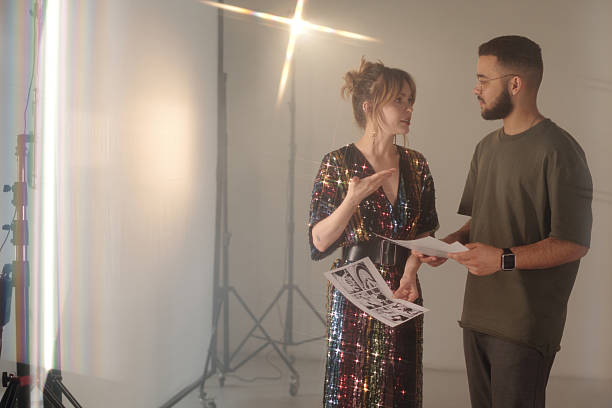 istock Young Woman Talking to Director Holding Concept Art Drafts 2212350743
