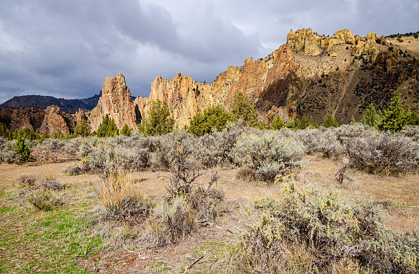 Terrebonne, OR, USA - October 06, 2025: Adventurous individuals are seen enjoying rock climbing on the iconic cliffs of Smith Rock State Park under a clear summer sky