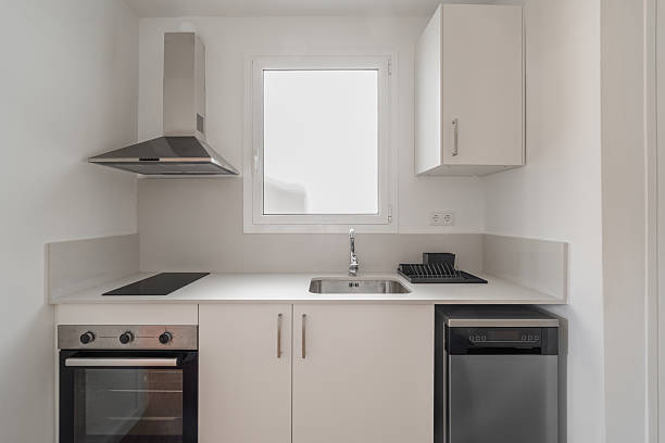istock Minimalist white kitchen with sleek cabinetry integrated oven and simple bright design 2212352556