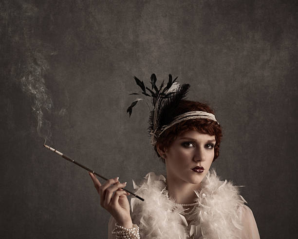 istock glamorous woman in 1920s flapper style smoking cigarette with holder 2212354944