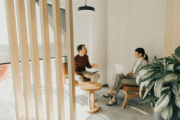 istock Engaging discussion between colleagues in a bright modern workspace during afternoon hours 2212355417