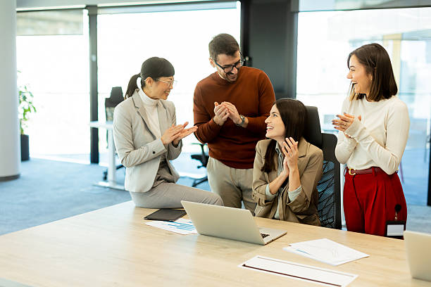 istock Team celebrates success together in a bright modern office environment 2212355432